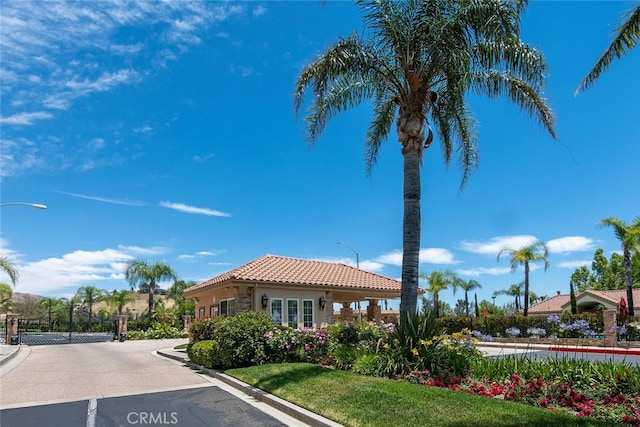 11884 Mariposa Bay Ln, Porter Ranch, CA 91326 - view of asphalt road with street lights, curbs, and a gated entry
