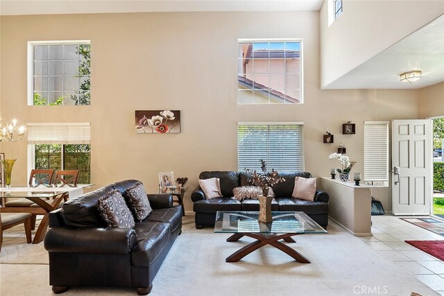 11884 Mariposa Bay Ln, Porter Ranch, CA 91326 - living area featuring a high ceiling, a chandelier, plenty of natural light, and tile patterned floors
