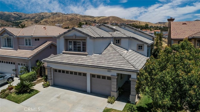11884 Mariposa Bay Ln, Porter Ranch, CA 91326 - traditional-style house featuring a mountain view, stucco siding, concrete driveway, an attached garage, and a tiled roof