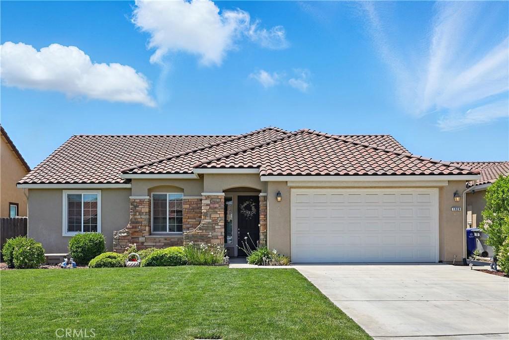1929 Pollitt Ct, Atwater, CA 95301 - mediterranean / spanish-style home featuring stucco siding, driveway, a front yard, an attached garage, and a tiled roof