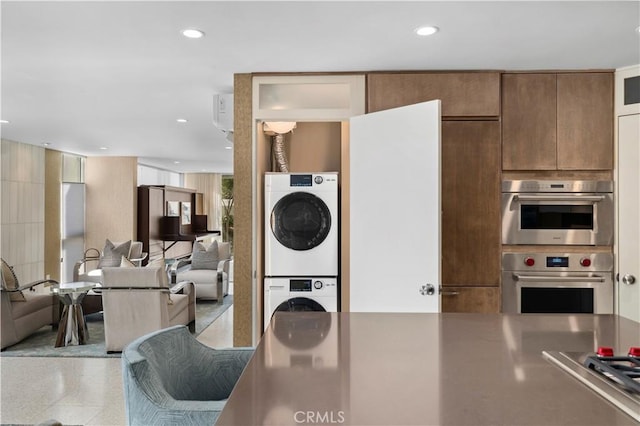 741 Avocado Ave Unit 101, Corona Del Mar, CA 92625 - kitchen featuring stacked washer / drying machine, open floor plan, recessed lighting, stainless steel gas stovetop, and stainless steel counters