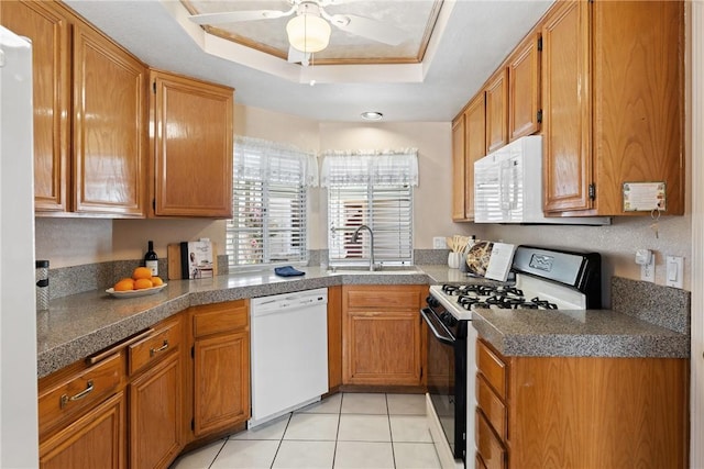 16051 Augusta Dr, Chino Hills, CA 91709 - kitchen with white appliances, a sink, a tray ceiling, a ceiling fan, and brown cabinetry