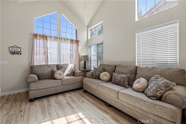 3314 Sandstone Ct, Palmdale, CA 93551 - living area featuring a high ceiling, wood finished floors, and baseboards
