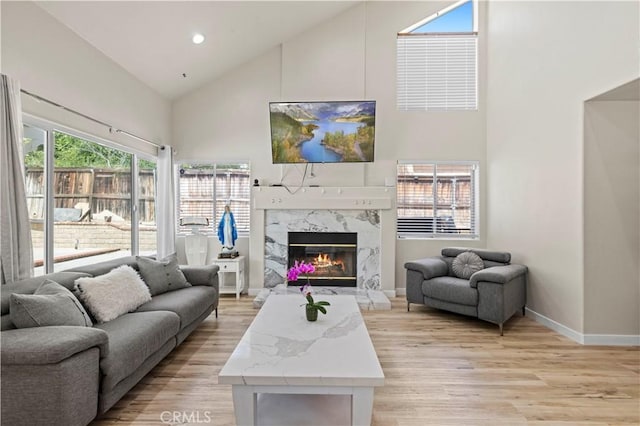3314 Sandstone Ct, Palmdale, CA 93551 - living area with high vaulted ceiling, light wood-style flooring, a premium fireplace, baseboards, and recessed lighting