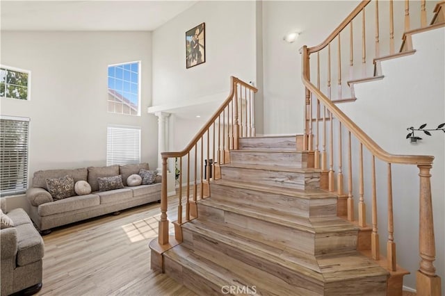 3314 Sandstone Ct, Palmdale, CA 93551 - stairway with plenty of natural light, a towering ceiling, and wood finished floors