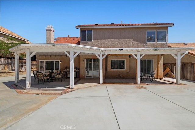 3314 Sandstone Ct, Palmdale, CA 93551 - rear view of house featuring a pergola, stucco siding, a patio, and a chimney