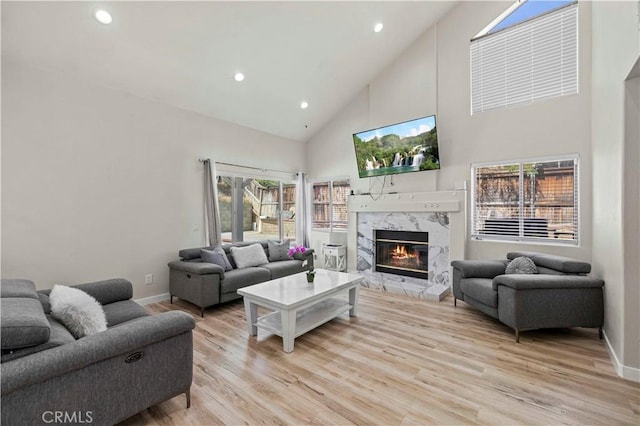 3314 Sandstone Ct, Palmdale, CA 93551 - living area featuring high vaulted ceiling, a fireplace, recessed lighting, light wood-style floors, and baseboards