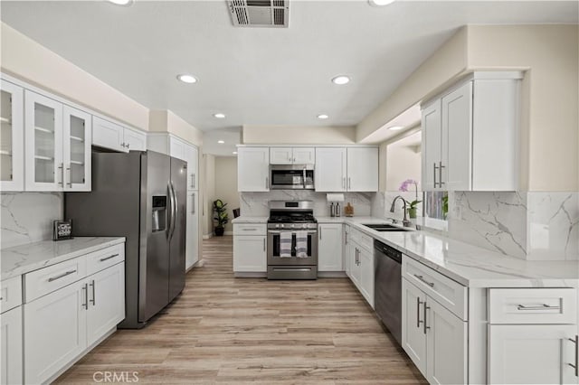 3314 Sandstone Ct, Palmdale, CA 93551 - kitchen with appliances with stainless steel finishes, a sink, white cabinets, recessed lighting, and light wood-style floors