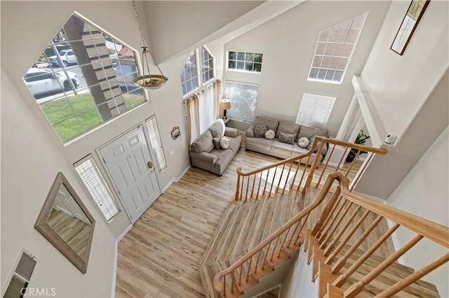 3314 Sandstone Ct, Palmdale, CA 93551 - foyer featuring a towering ceiling, wood finished floors, stairway, and baseboards