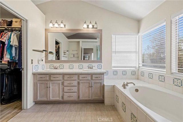 3314 Sandstone Ct, Palmdale, CA 93551 - bathroom with a garden tub, double vanity, plenty of natural light, a spacious closet, and lofted ceiling