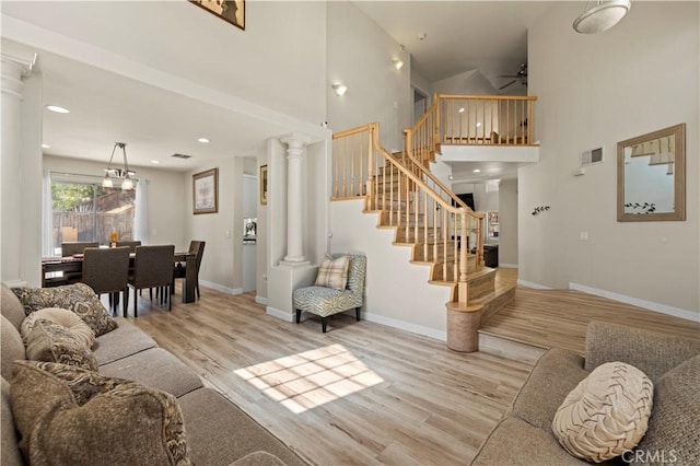3314 Sandstone Ct, Palmdale, CA 93551 - living room featuring wood finished floors, a high ceiling, stairs, baseboards, and a ceiling fan