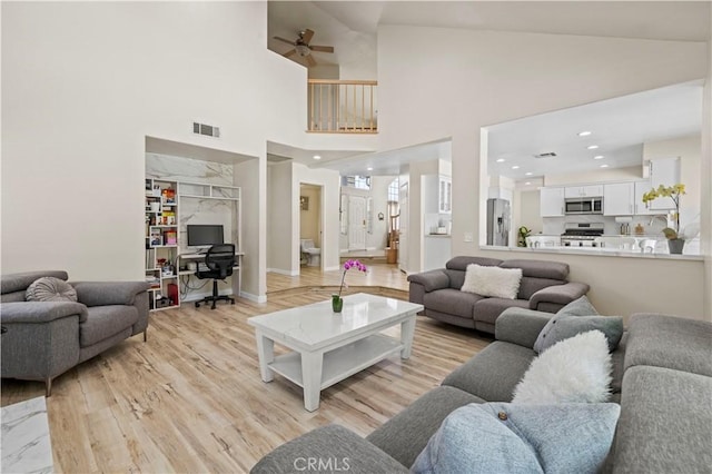 3314 Sandstone Ct, Palmdale, CA 93551 - living room featuring a ceiling fan, light wood-style floors, high vaulted ceiling, a desk, and recessed lighting