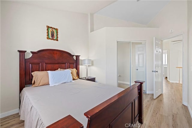 3314 Sandstone Ct, Palmdale, CA 93551 - bedroom with light wood-style flooring, vaulted ceiling, a closet, and baseboards