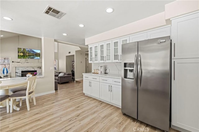 3314 Sandstone Ct, Palmdale, CA 93551 - kitchen with stainless steel refrigerator with ice dispenser, light wood-style floors, recessed lighting, open floor plan, and white cabinetry