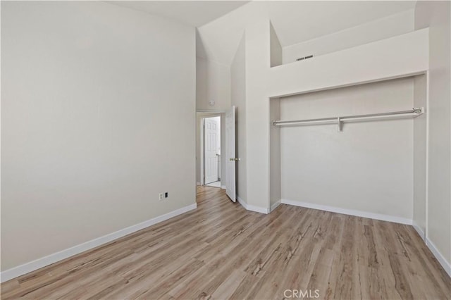 3314 Sandstone Ct, Palmdale, CA 93551 - unfurnished bedroom featuring baseboards, wood finished floors, a closet, and high vaulted ceiling