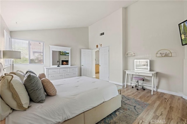 3314 Sandstone Ct, Palmdale, CA 93551 - bedroom with light wood finished floors, baseboards, and high vaulted ceiling