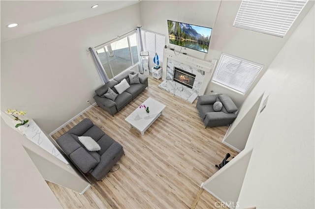 3314 Sandstone Ct, Palmdale, CA 93551 - living room with wood finished floors, a towering ceiling, recessed lighting, and a high end fireplace