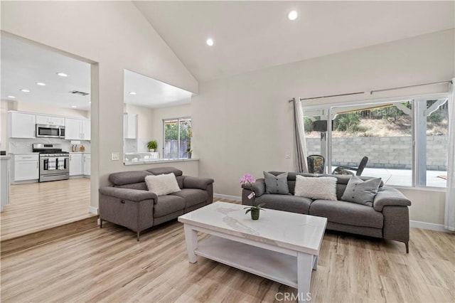 3314 Sandstone Ct, Palmdale, CA 93551 - living area with light wood finished floors, baseboards, high vaulted ceiling, and recessed lighting