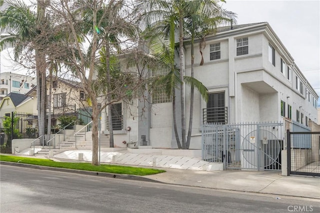957 S Gramercy Dr Unit 105, Los Angeles, CA 90019 - view of property featuring a gate and stucco siding