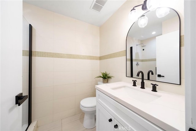 957 S Gramercy Dr Unit 105, Los Angeles, CA 90019 - bathroom featuring vanity, toilet, a shower, and tile walls