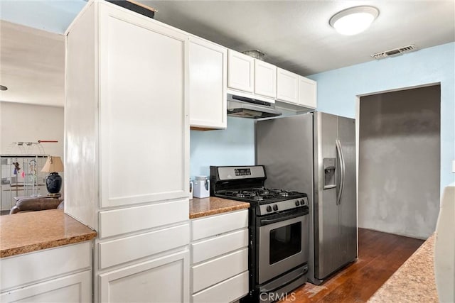 1524 Keko St, Oroville, CA 95965 - kitchen with stainless steel gas range oven, under cabinet range hood, dark wood finished floors, white cabinetry, and light countertops