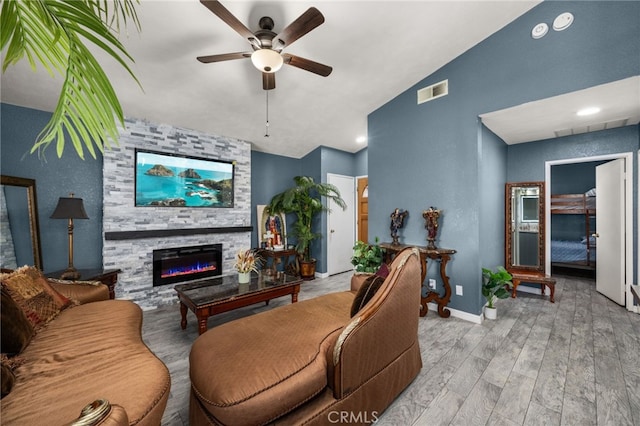 24457 Liolios Way, Moreno Valley, CA 92551 - living area with ceiling fan, a fireplace, vaulted ceiling, wood finished floors, and baseboards