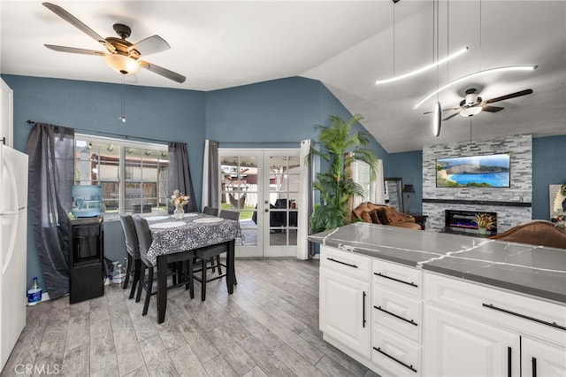 24457 Liolios Way, Moreno Valley, CA 92551 - kitchen with a ceiling fan, open floor plan, light wood-style flooring, a fireplace, and french doors
