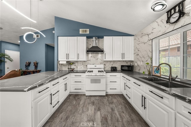 24457 Liolios Way, Moreno Valley, CA 92551 - kitchen with gas range gas stove, wall chimney range hood, a sink, a peninsula, and white cabinets