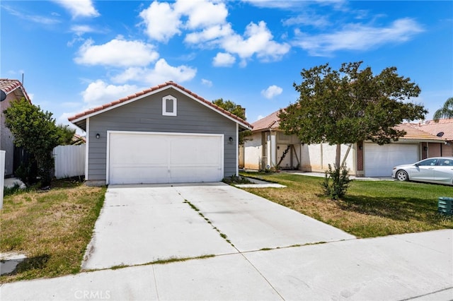 24457 Liolios Way, Moreno Valley, CA 92551 - view of front of home featuring a tiled roof, a front yard, and a detached garage