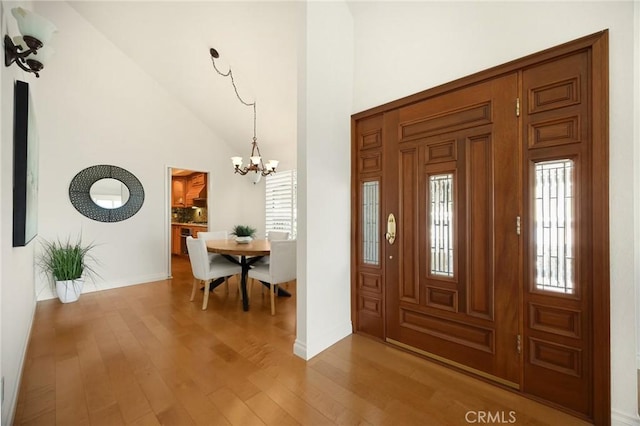 2365 Sommerset Dr, Brea, CA 92821 - foyer entrance with a chandelier, wood finished floors, high vaulted ceiling, and baseboards