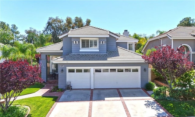 27324 Chesterfield Dr, Valencia, CA 91354 - traditional-style home featuring a chimney, driveway, and a garage