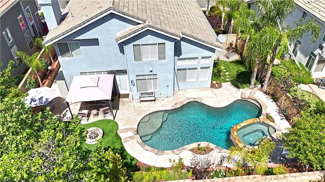 27324 Chesterfield Dr, Valencia, CA 91354 - back of property with a pool with connected hot tub, a patio area, stucco siding, a shingled roof, and a bar