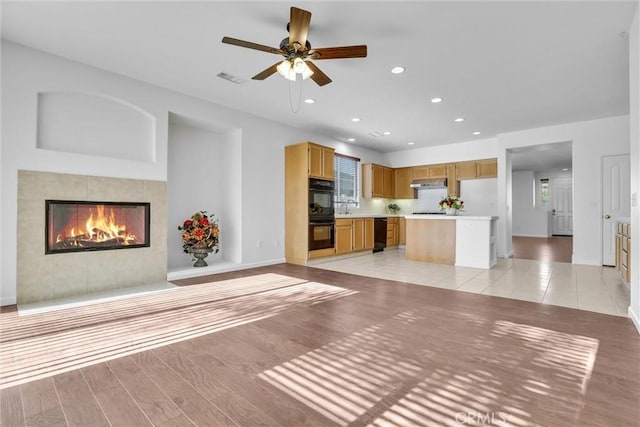 62 Rio Grande St, Fillmore, CA 93015 - unfurnished living room featuring baseboards, ceiling fan, recessed lighting, a fireplace, and light wood-style flooring