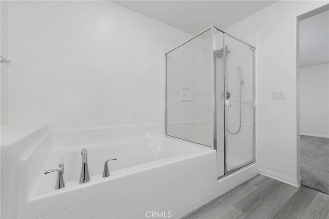 7453 Jersey St, Chino, CA 91708 - bathroom with a stall shower, a bath, and wood finished floors