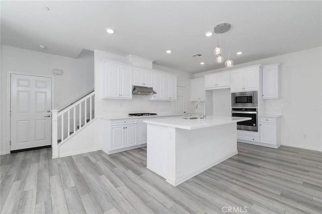 7453 Jersey St, Chino, CA 91708 - kitchen with stainless steel appliances, a sink, white cabinets, and recessed lighting