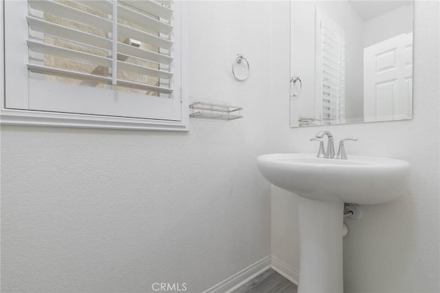 7453 Jersey St, Chino, CA 91708 - bathroom featuring baseboards and a sink