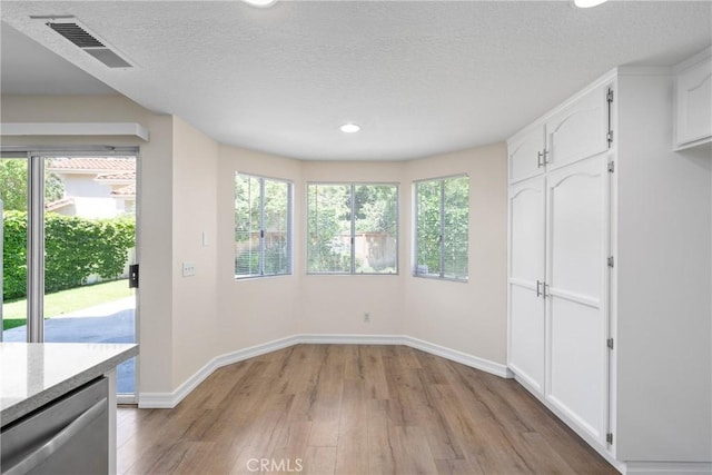 3 Andria, Irvine, CA 92614 - unfurnished dining area with light wood-type flooring, plenty of natural light, baseboards, recessed lighting, and a textured ceiling
