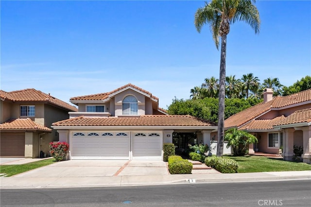 3 Andria, Irvine, CA 92614 - mediterranean / spanish-style home featuring an attached garage, a tiled roof, driveway, and stucco siding