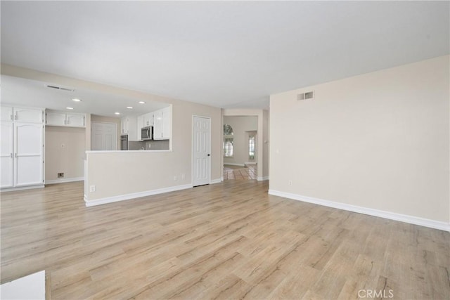 3 Andria, Irvine, CA 92614 - unfurnished living room with light wood-style floors, baseboards, and recessed lighting