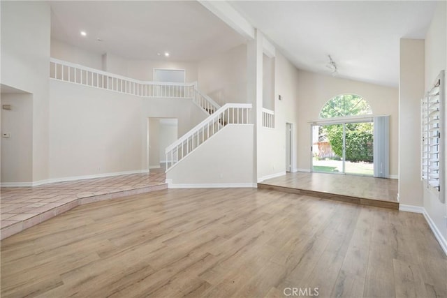 3 Andria, Irvine, CA 92614 - unfurnished living room featuring wood finished floors, high vaulted ceiling, stairway, recessed lighting, and baseboards