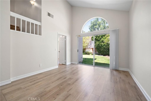 3 Andria, Irvine, CA 92614 - empty room with wood finished floors, baseboards, and a towering ceiling