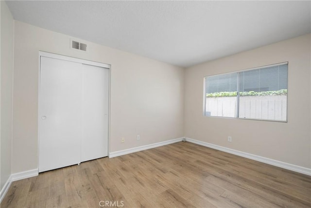 3 Andria, Irvine, CA 92614 - unfurnished bedroom with wood finished floors, baseboards, and a closet