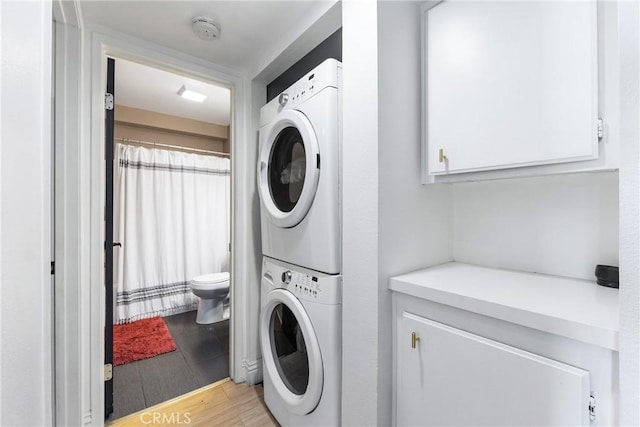 26873 Claudette St Unit 112, Canyon Country, CA 91351 - laundry area featuring stacked washer and clothes dryer and light wood-type flooring