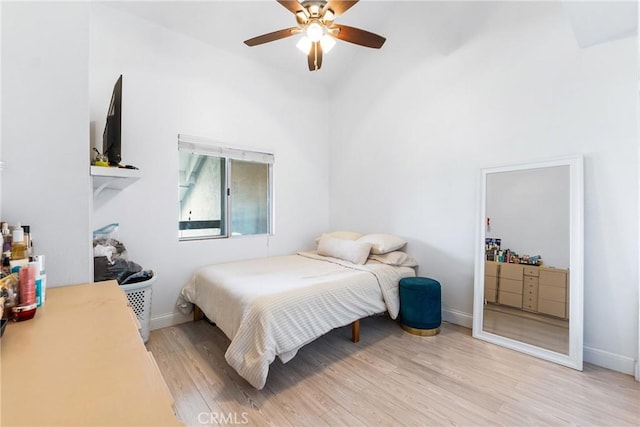 26873 Claudette St Unit 112, Canyon Country, CA 91351 - bedroom featuring light wood finished floors, vaulted ceiling, baseboards, and a ceiling fan