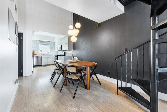 26873 Claudette St Unit 112, Canyon Country, CA 91351 - dining room with light wood finished floors and baseboards