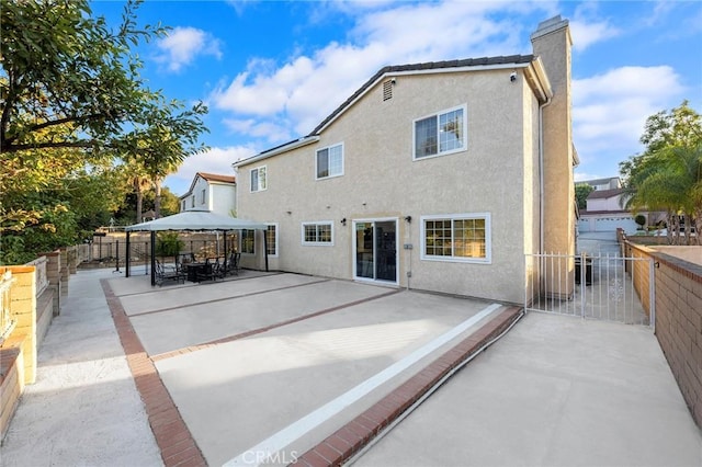 19519 Greenwillow Ln, Rowland Heights, CA 91748 - rear view of house featuring a gazebo, a chimney, stucco siding, and a patio