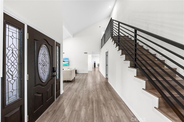 19519 Greenwillow Ln, Rowland Heights, CA 91748 - foyer featuring wood finished floors, high vaulted ceiling, baseboards, and stairs