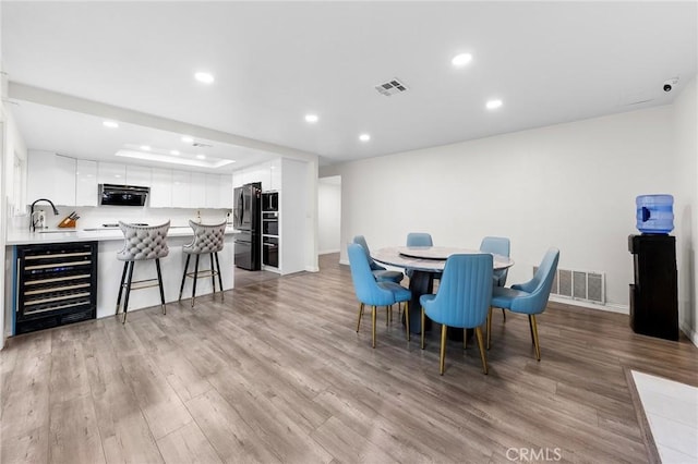19519 Greenwillow Ln, Rowland Heights, CA 91748 - dining space with beverage cooler, light wood-type flooring, recessed lighting, and baseboards