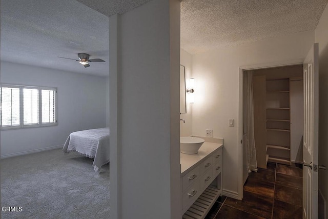 631 Wilcox Ave Unit 2E, Los Angeles, CA 90004 - ensuite bathroom with a textured ceiling, vanity, ceiling fan, and baseboards