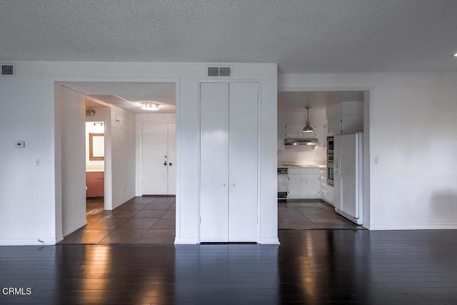 631 Wilcox Ave Unit 2E, Los Angeles, CA 90004 - unfurnished room with dark wood-type flooring, baseboards, and a textured ceiling